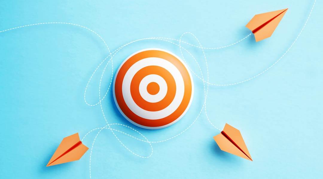 Paper Planes Flying Around An Orange Bull's Eye Target On Blue Background