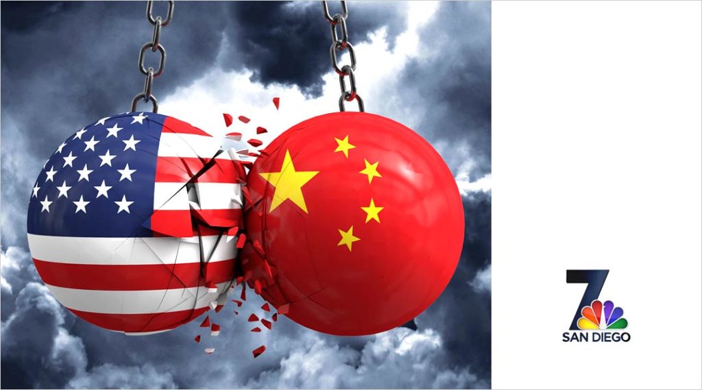 two wrecking balls colliding one with use glag the other chinese flag